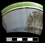 London-shape bowl with mocha decoration against blue slip. Green-glazed herringbone rouletted rim, 5.5” rim diameter - from 18BC79.